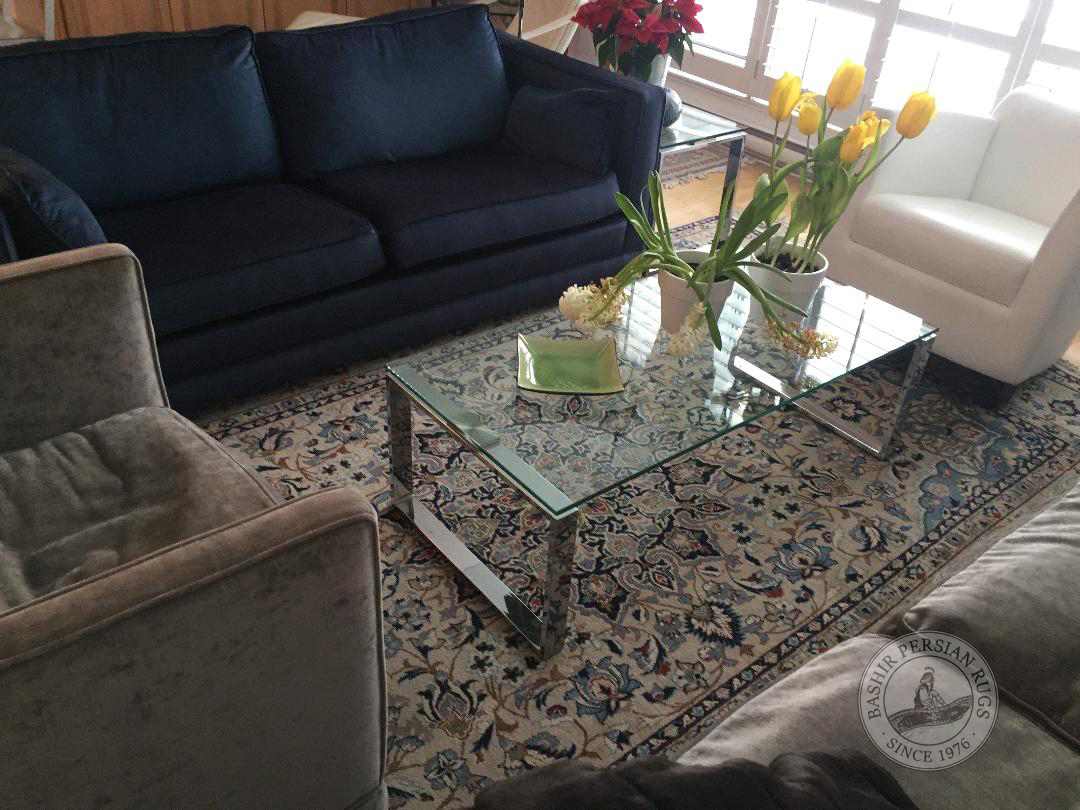 Evaluated Persian rug featured in a modern living room setting. Snapshot sent to us by one of our very happy customer.